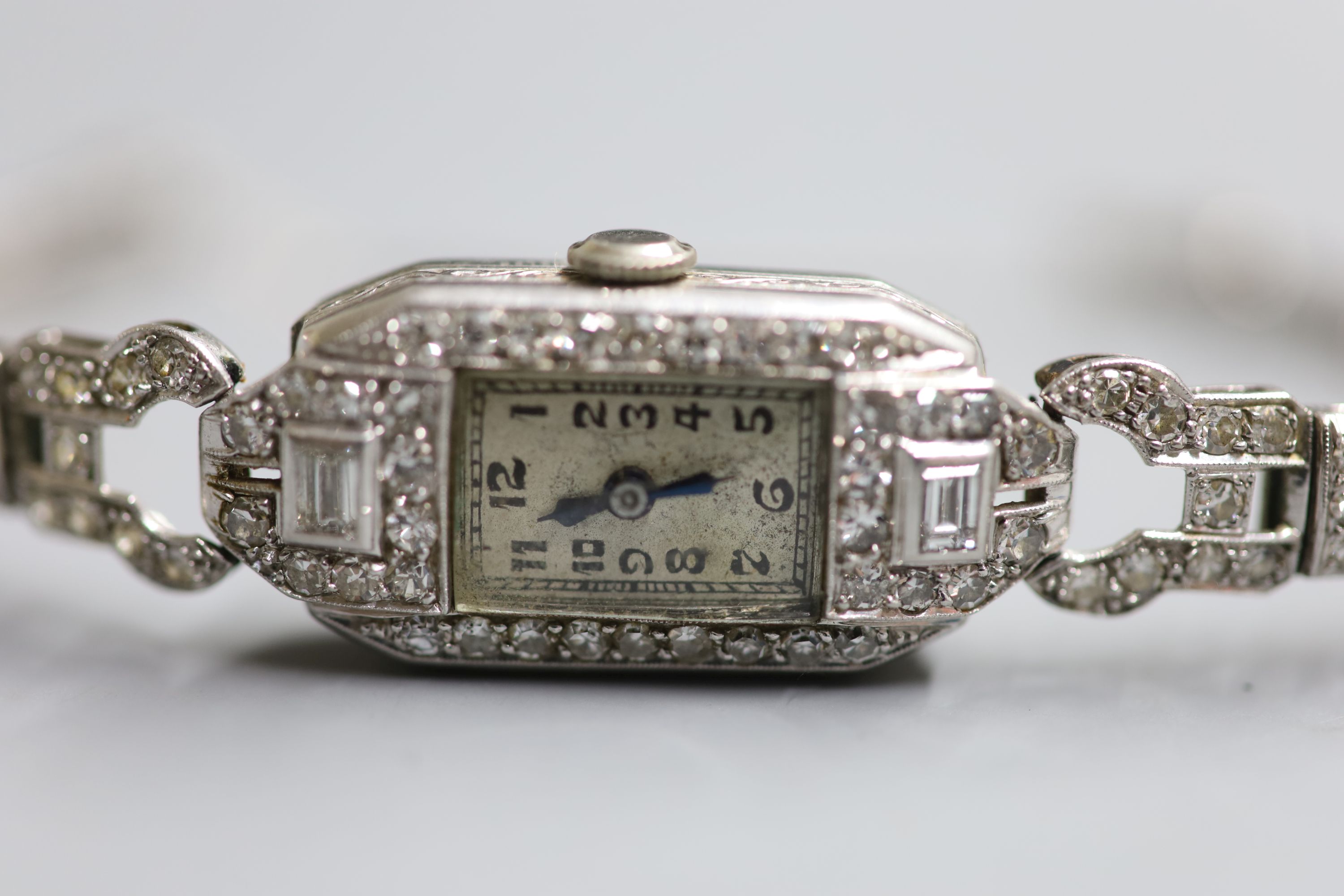 A ladys 1940s white metal (stamped platinum) and diamond set cocktail watch,